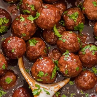 Delicious grape jelly meatballs on a serving platter for a crowd-pleasing appetizer.