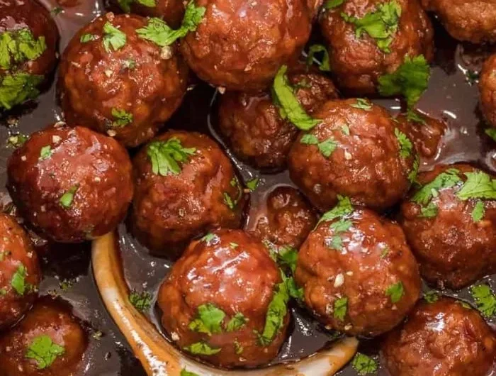 Delicious grape jelly meatballs on a serving platter for a crowd-pleasing appetizer.