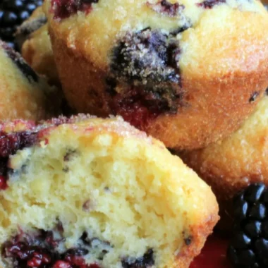 Delicious homemade blackberry muffins with fresh blackberries on a cooling rack