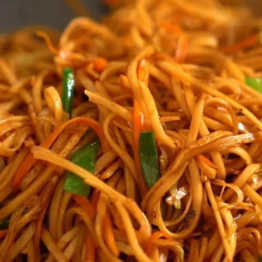 Delicious homemade Chow Mein served in a bowl with colorful vegetables and noodles.