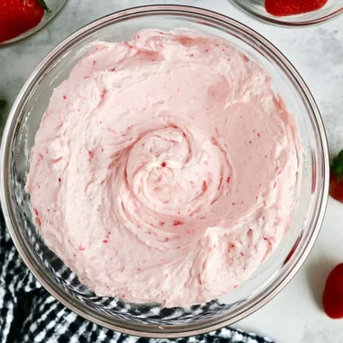 Delicious homemade fresh strawberry buttercream spread on a cupcake.