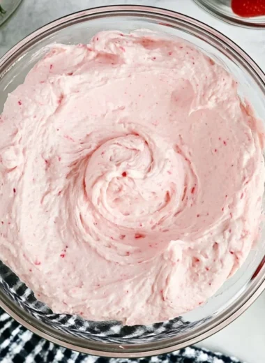 Delicious homemade fresh strawberry buttercream spread on a cupcake.