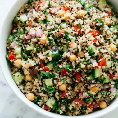 Colorful healthy quinoa salad with vegetables and dressing.