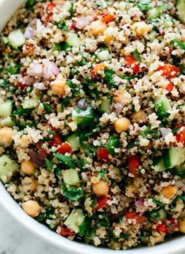 Colorful healthy quinoa salad with vegetables and dressing.