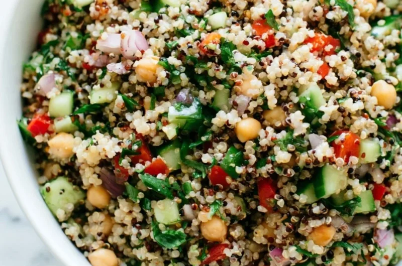 Colorful healthy quinoa salad with vegetables and dressing.
