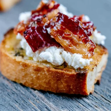 Bacon Goat Cheese Appetizer Log garnished with herbs and spices