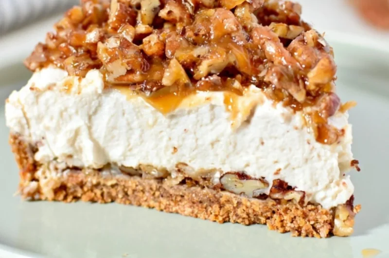 No-bake keto pecan pie cheesecake topped with pecans and caramel drizzle