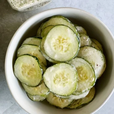 Fresh ranch cucumber chips served in a bowl, a healthy snack option.