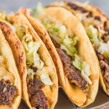 Smash Burger Tacos with juicy beef, fresh toppings, and taco shells