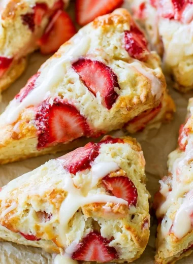Freshly baked strawberries and cream scones on a plate