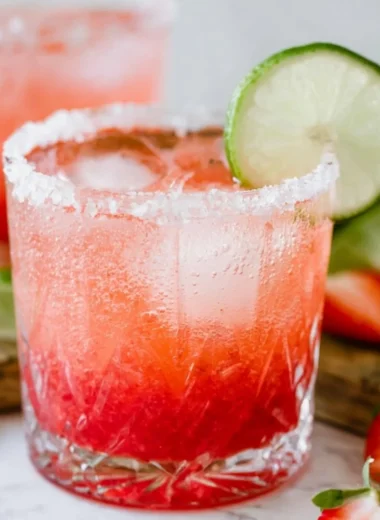 Strawberry Lime Mocktail Margarita in a glass with fresh strawberries and limes