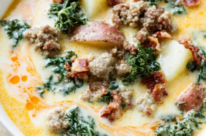 A steaming bowl of Instant Pot Tuscan soup with fresh ingredients and herbs.