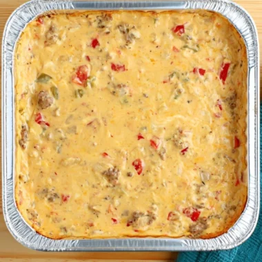 Cozy smoked cheese dip served in a bowl with fresh herbs and chips for dipping.