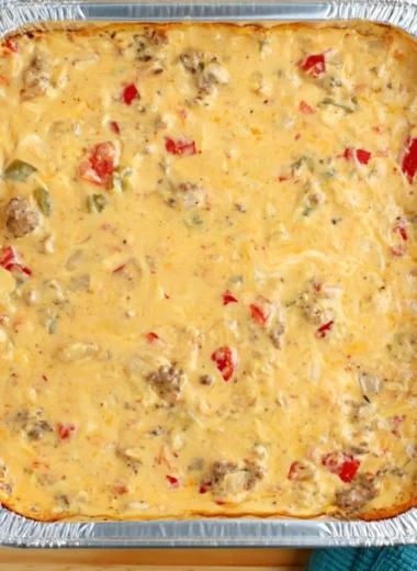 Cozy smoked cheese dip served in a bowl with fresh herbs and chips for dipping.