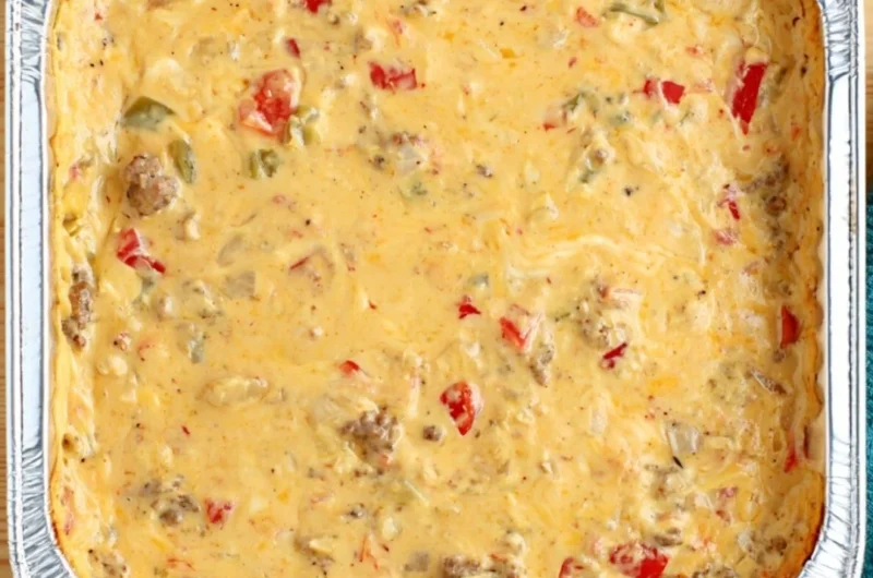 Cozy smoked cheese dip served in a bowl with fresh herbs and chips for dipping.