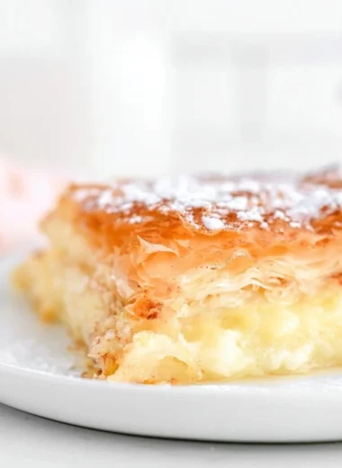 Freshly baked Greek Bougatsa custard pastry served on a plate.