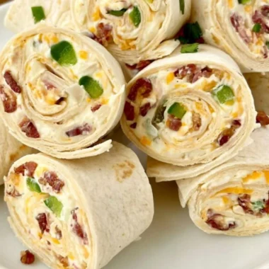 Jalapeno poppers pinwheels on a serving platter with toppings