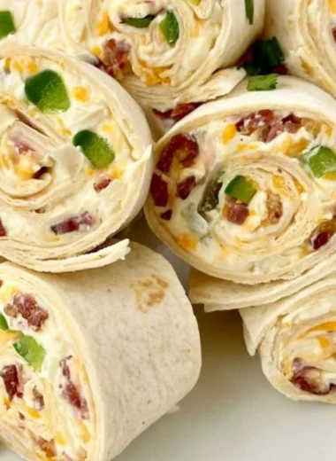 Jalapeno poppers pinwheels on a serving platter with toppings