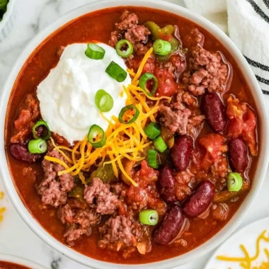 Bowl of Old Fashioned Chili topped with cheese and cilantro