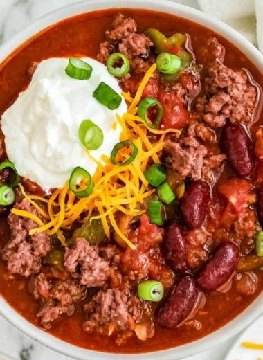 Bowl of Old Fashioned Chili topped with cheese and cilantro