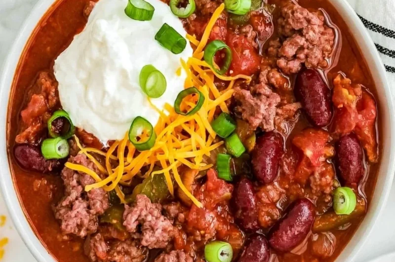 Bowl of Old Fashioned Chili topped with cheese and cilantro