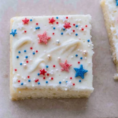 Patriotic sugar cookie bars decorated with red, white, and blue frosting.