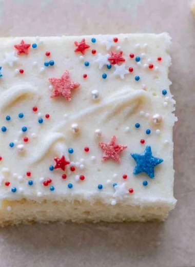 Patriotic sugar cookie bars decorated with red, white, and blue frosting.