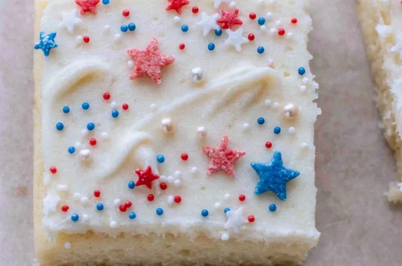 Patriotic sugar cookie bars decorated with red, white, and blue frosting.