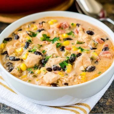 Bowl of Southwest Creamy White Chicken Chili garnished with cilantro and lime