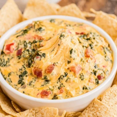 Delicious spinach dip served with assorted snacks at a party