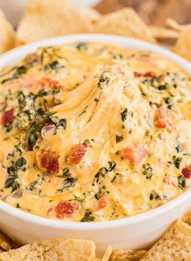 Delicious spinach dip served with assorted snacks at a party