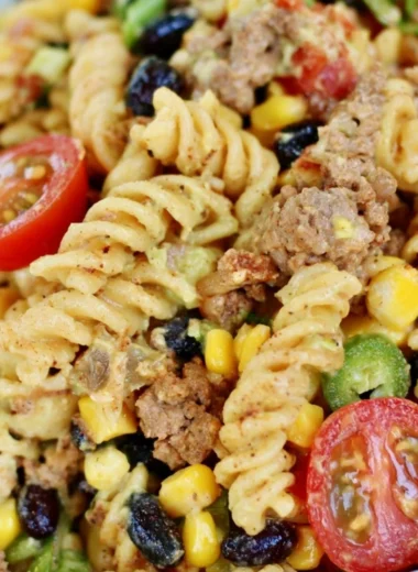 Cozy taco pasta salad garnished with fresh cilantro and diced tomatoes